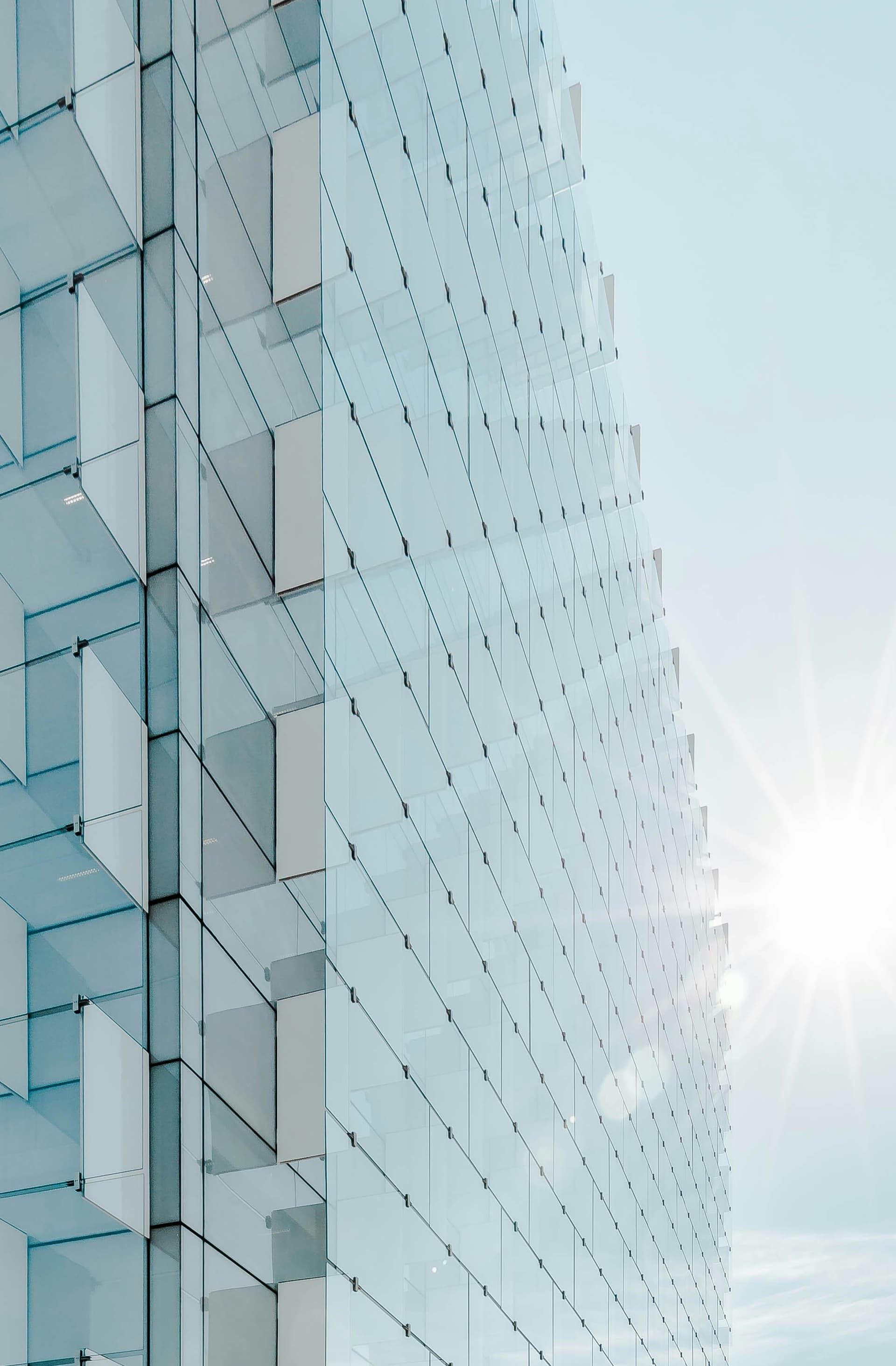 Glass building facade closeup with sun flare